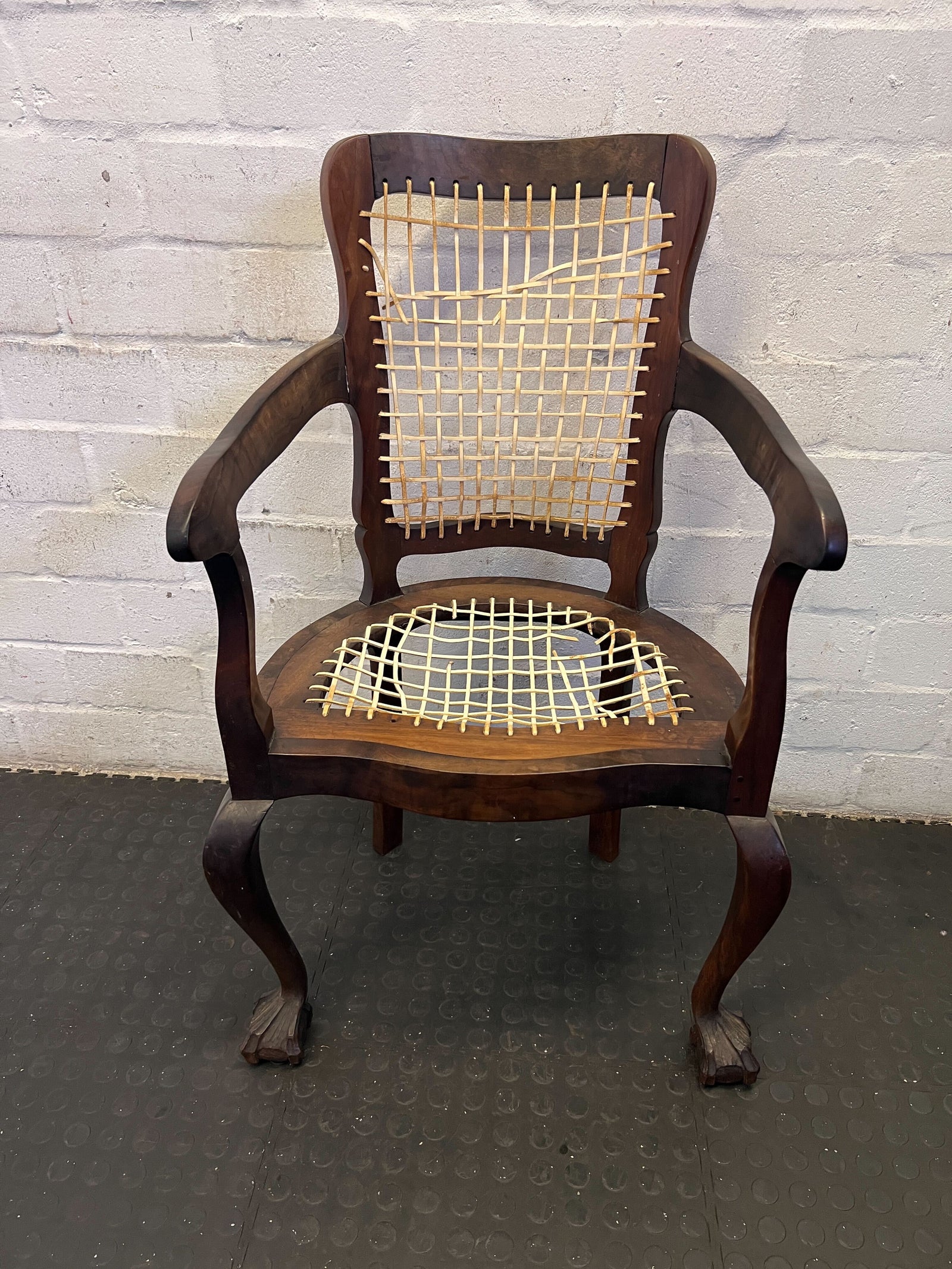 Elegant Vintage Dark Wood Armchair with Woven Seat