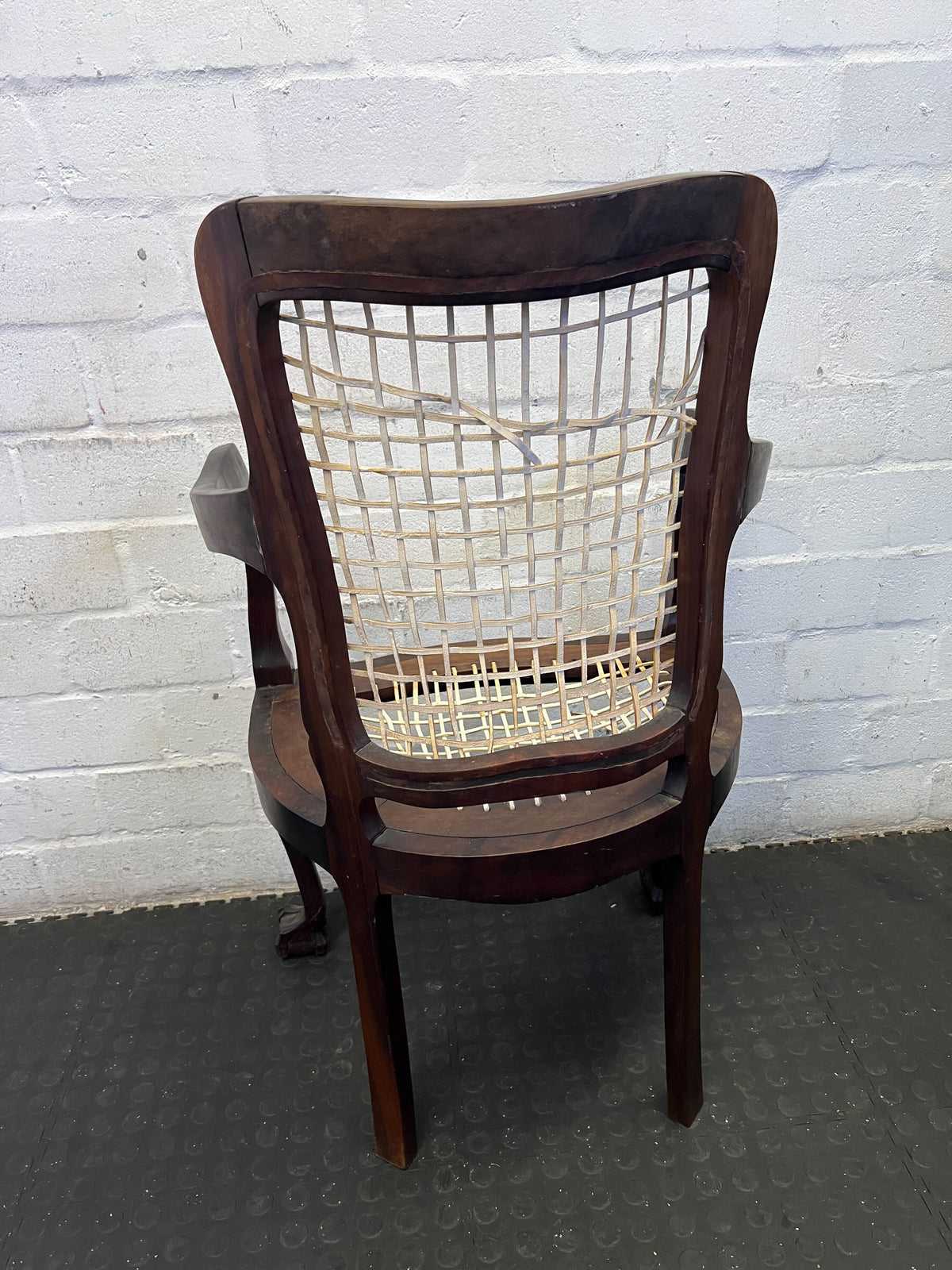 Elegant Vintage Dark Wood Armchair with Woven Seat