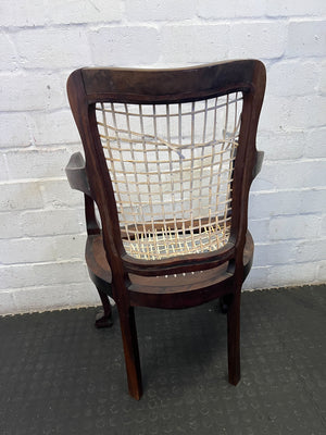 Elegant Vintage Dark Wood Armchair with Woven Seat