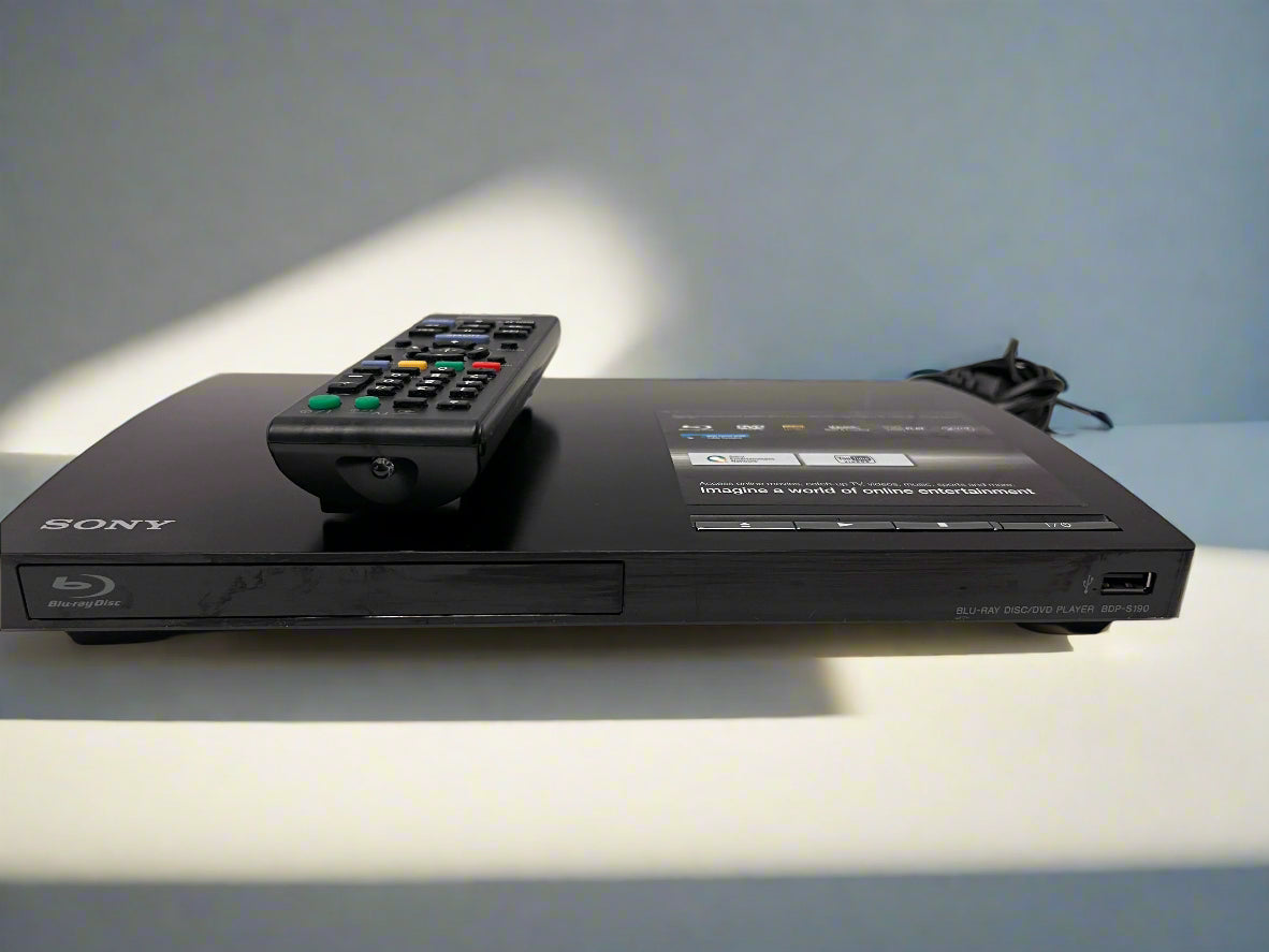 Sony DVD player with remote control on a light surface