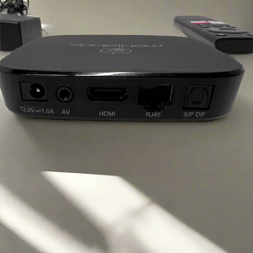 Black electronic device with multiple ports on a light surface