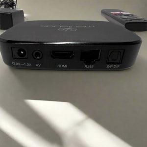 Black electronic device with multiple ports on a light surface