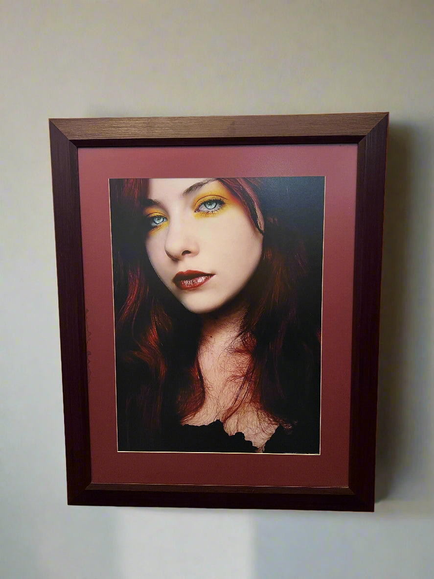 striking framed portrait with maroon matting and dark wood frame
