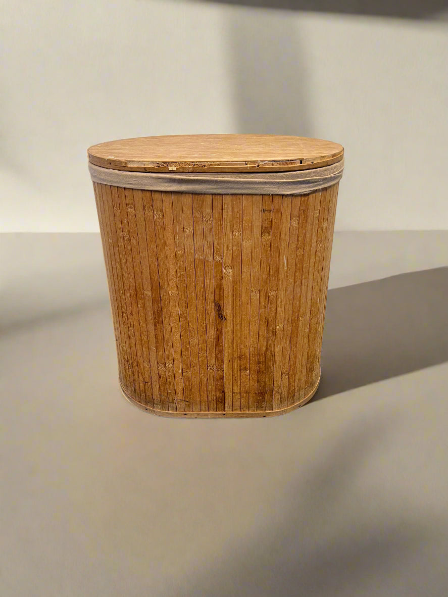 Bamboo laundry basket with a lid on a neutral background