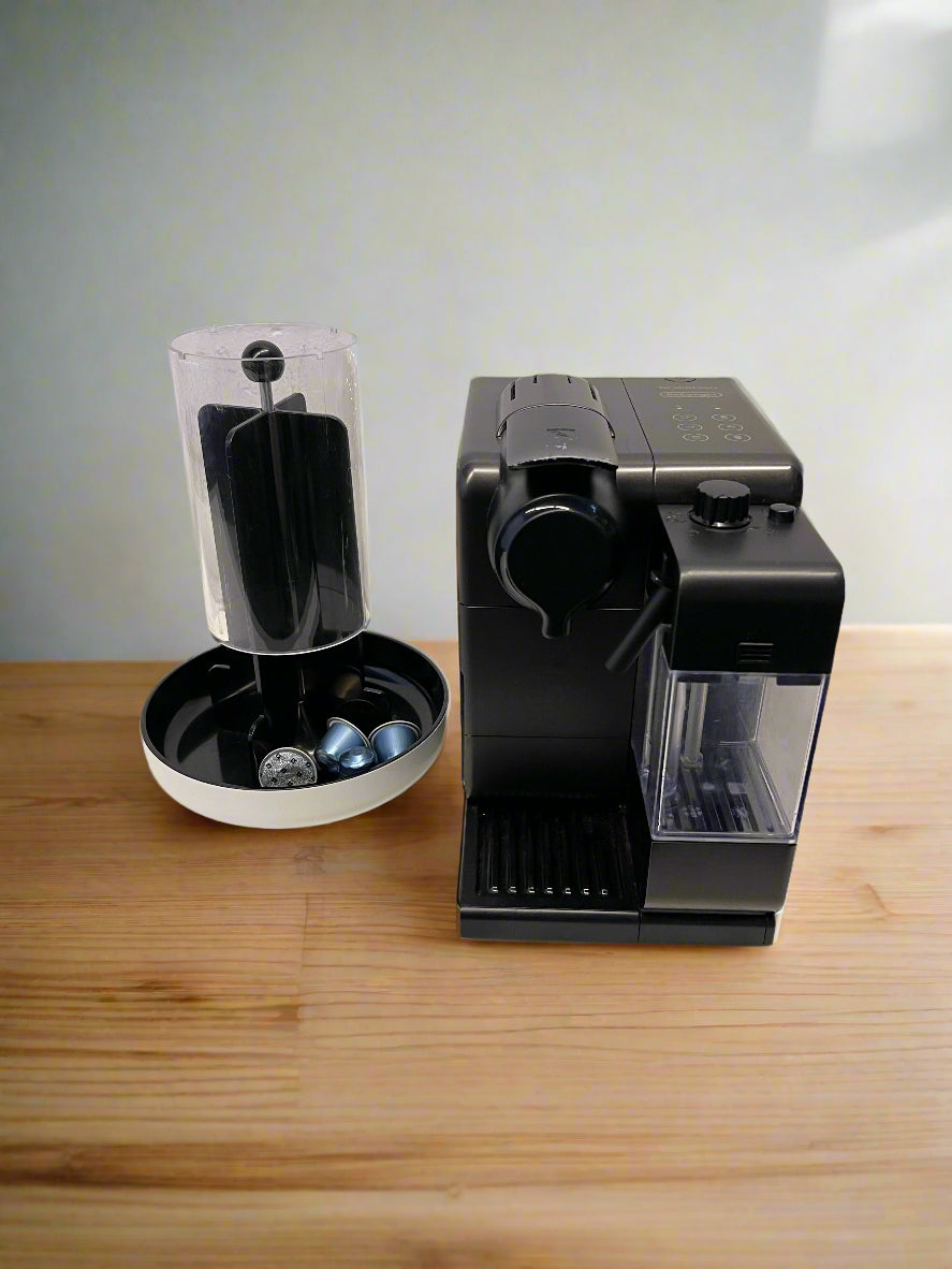Black coffee machine on a wooden surface with a white background