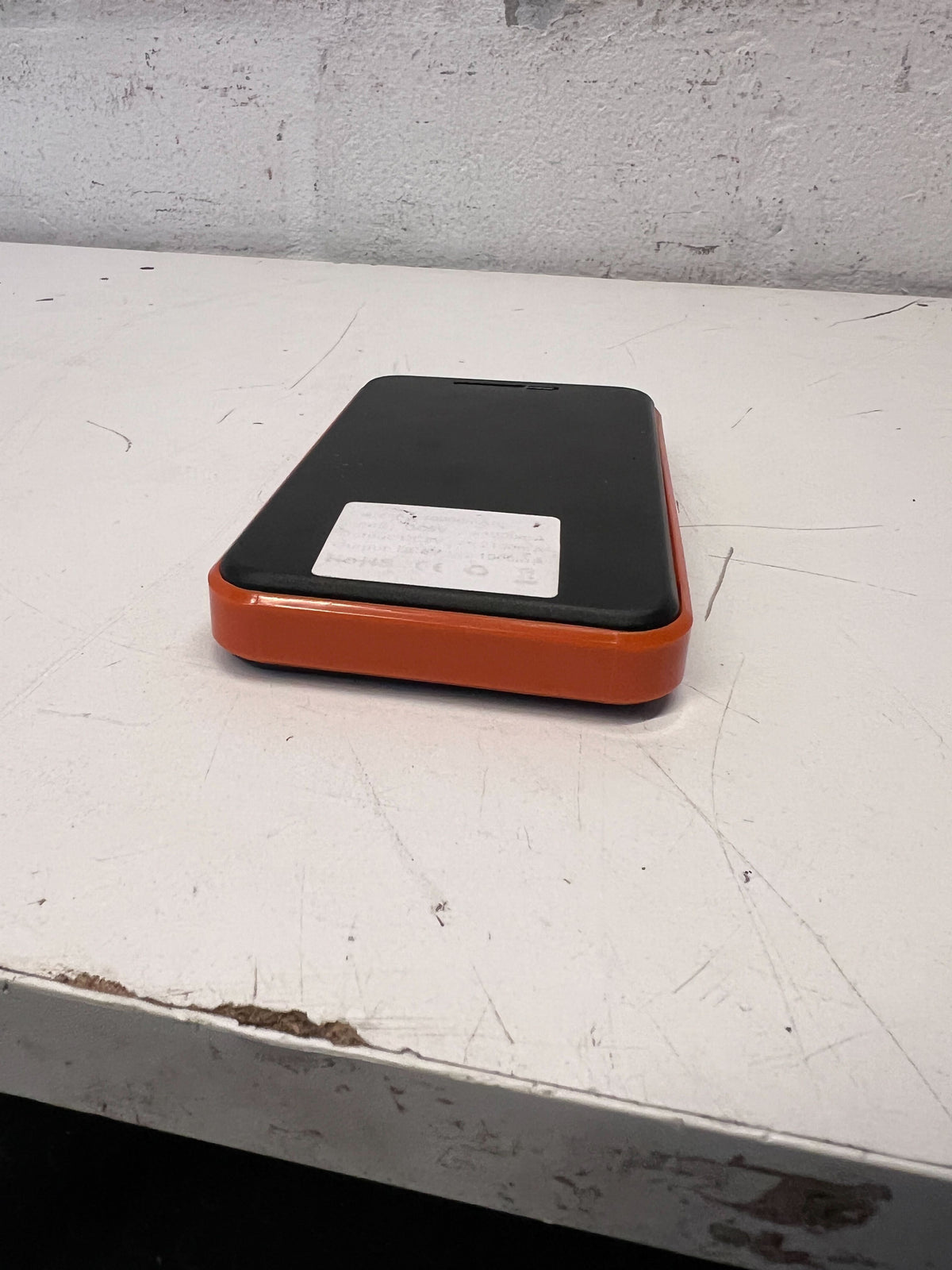 Compact Solar Power Bank with Durable Orange Edge – Excellent Condition