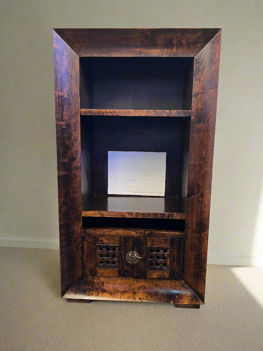 Wooden entertainment console with shelves against a plain wall