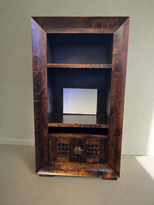 Wooden entertainment console with shelves against a plain wall