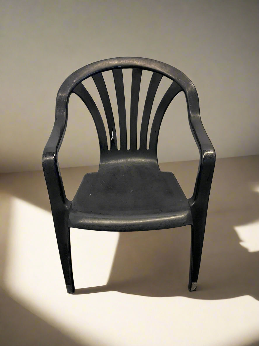 Durable Black Plastic Chair with Minor Scratches