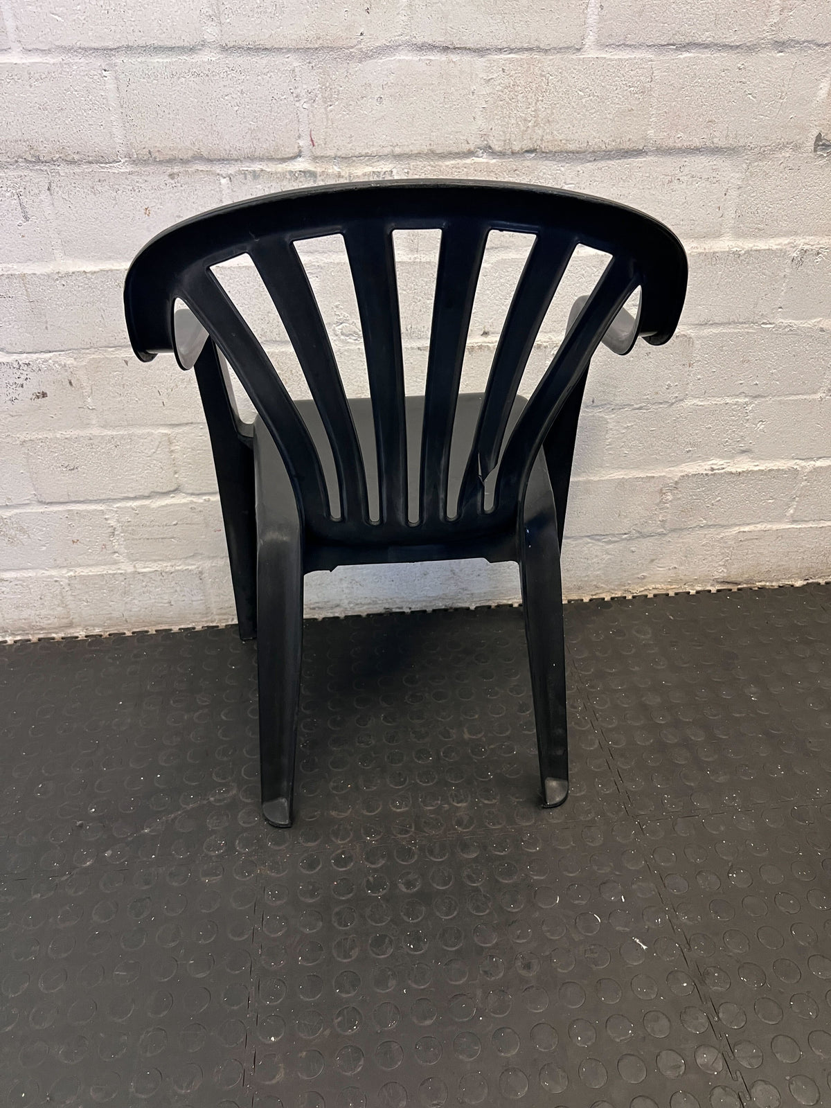 Durable Black Plastic Chair with Minor Scratches