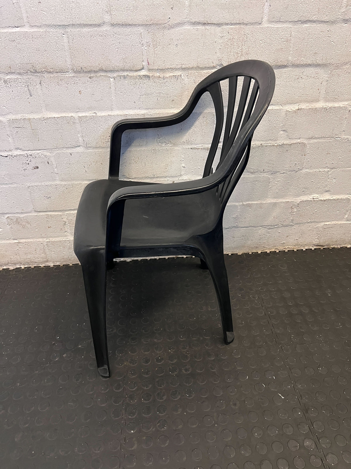 Durable Black Plastic Chair with Minor Scratches