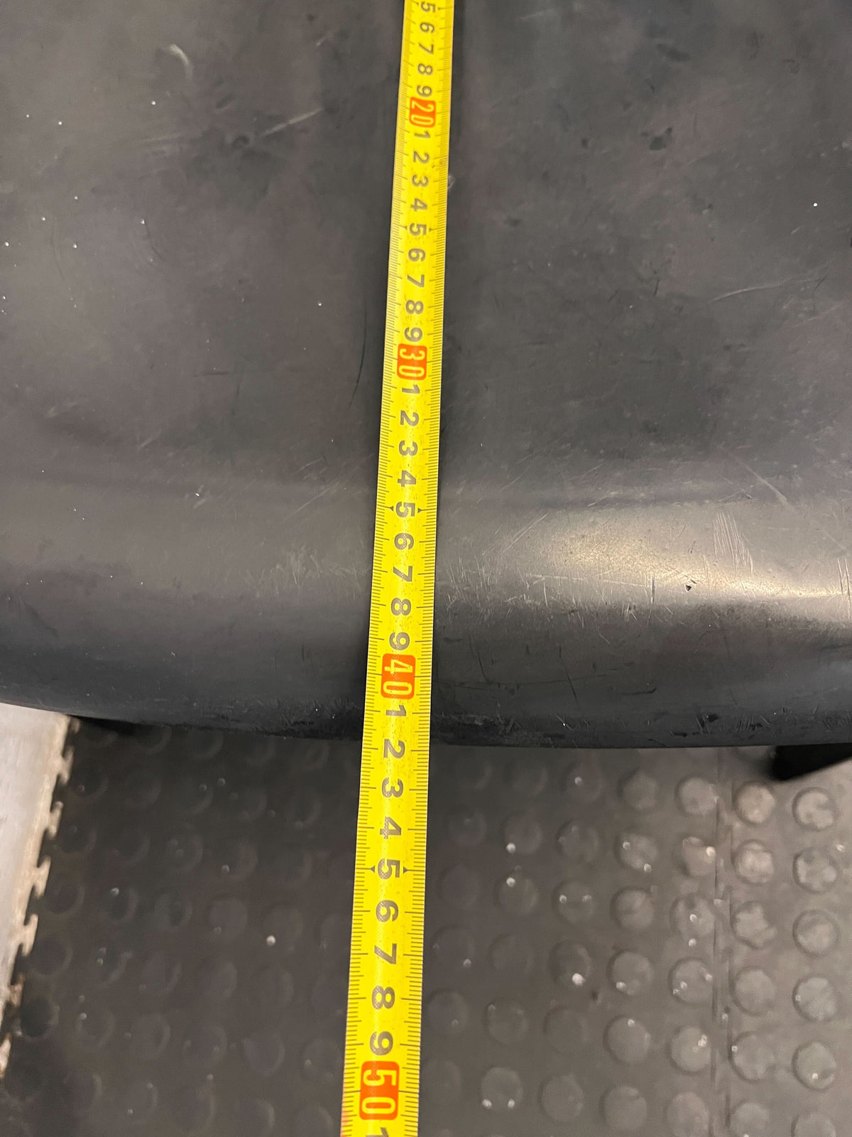 Durable Black Plastic Chair with Minor Scratches