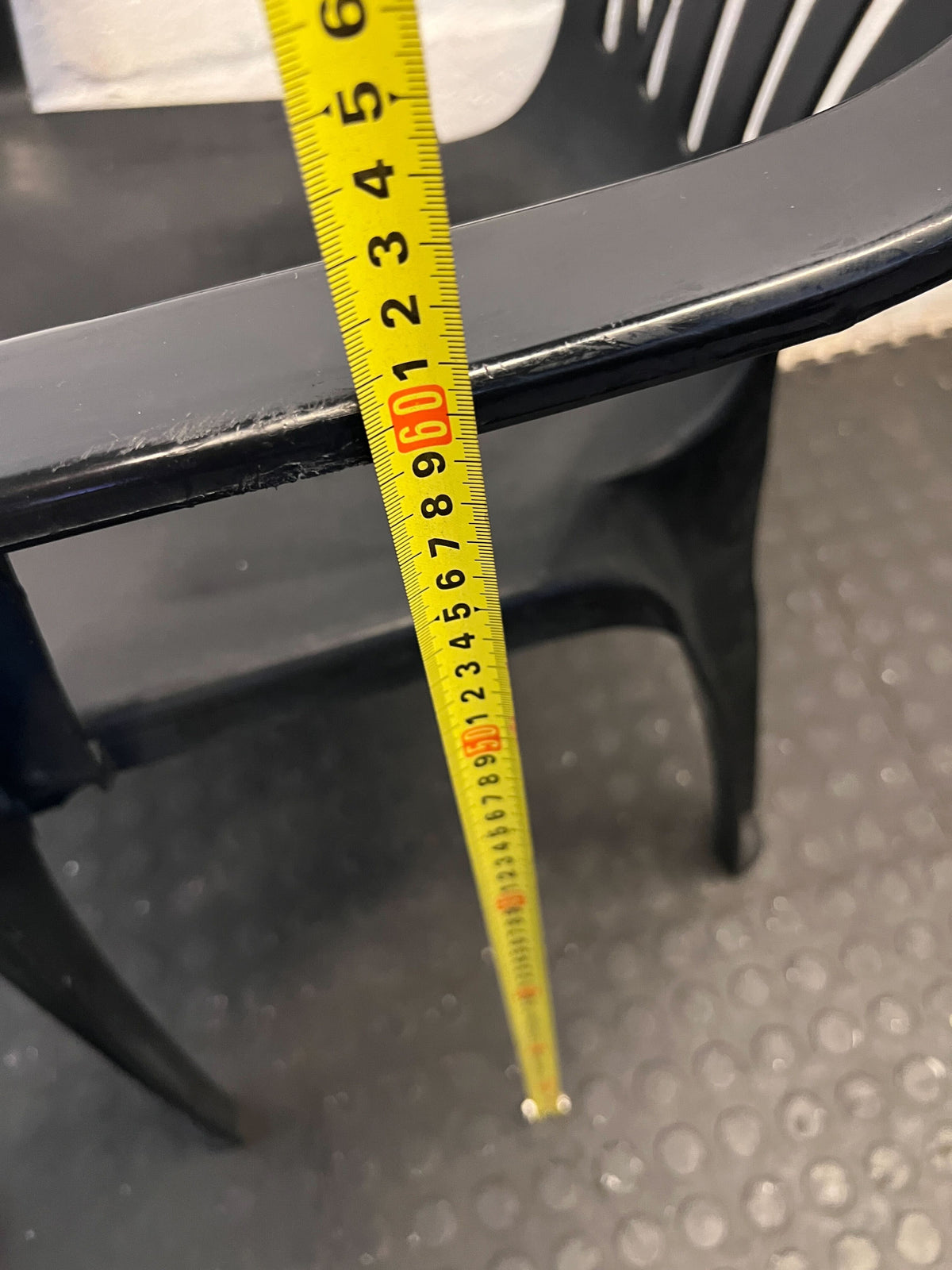 Durable Black Plastic Chair with Minor Scratches