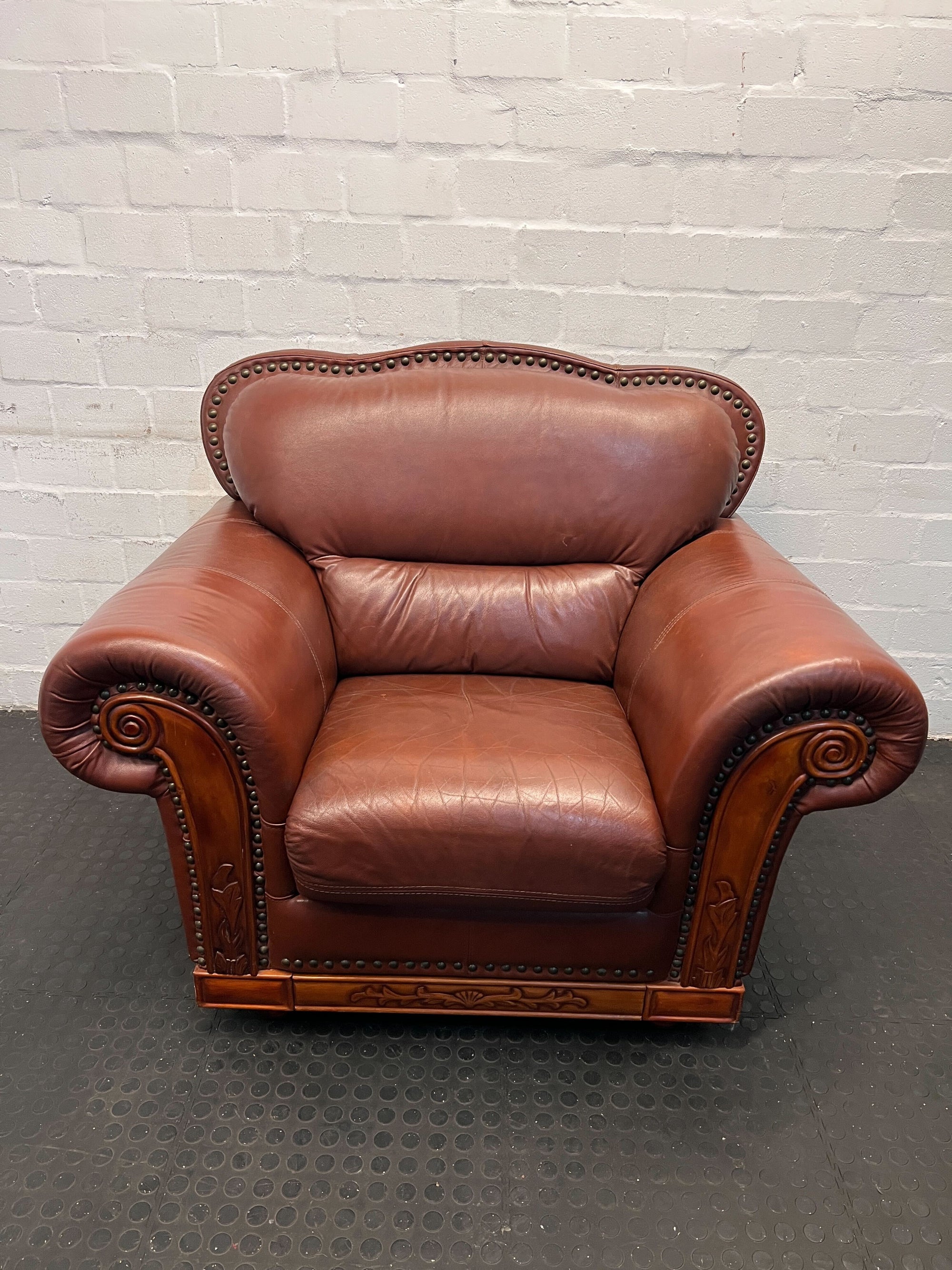 Classic Brown Leather Armchair with Intricate Detailing