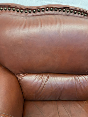 Classic Brown Leather Armchair with Intricate Detailing