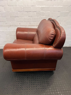 Classic Brown Leather Armchair with Intricate Detailing