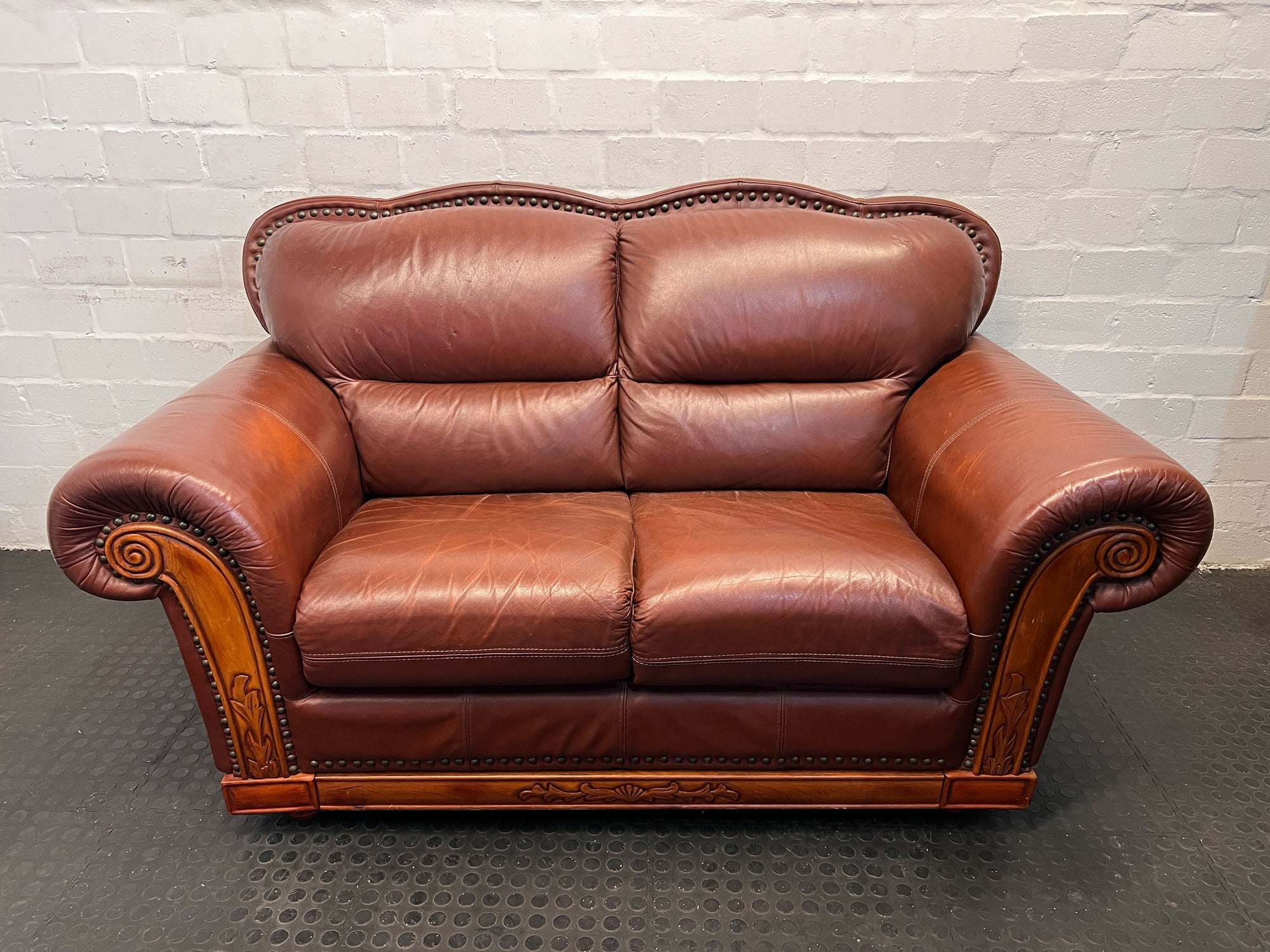 Elegant Brown Leather Loveseat with Wood Accents - small fabric damage