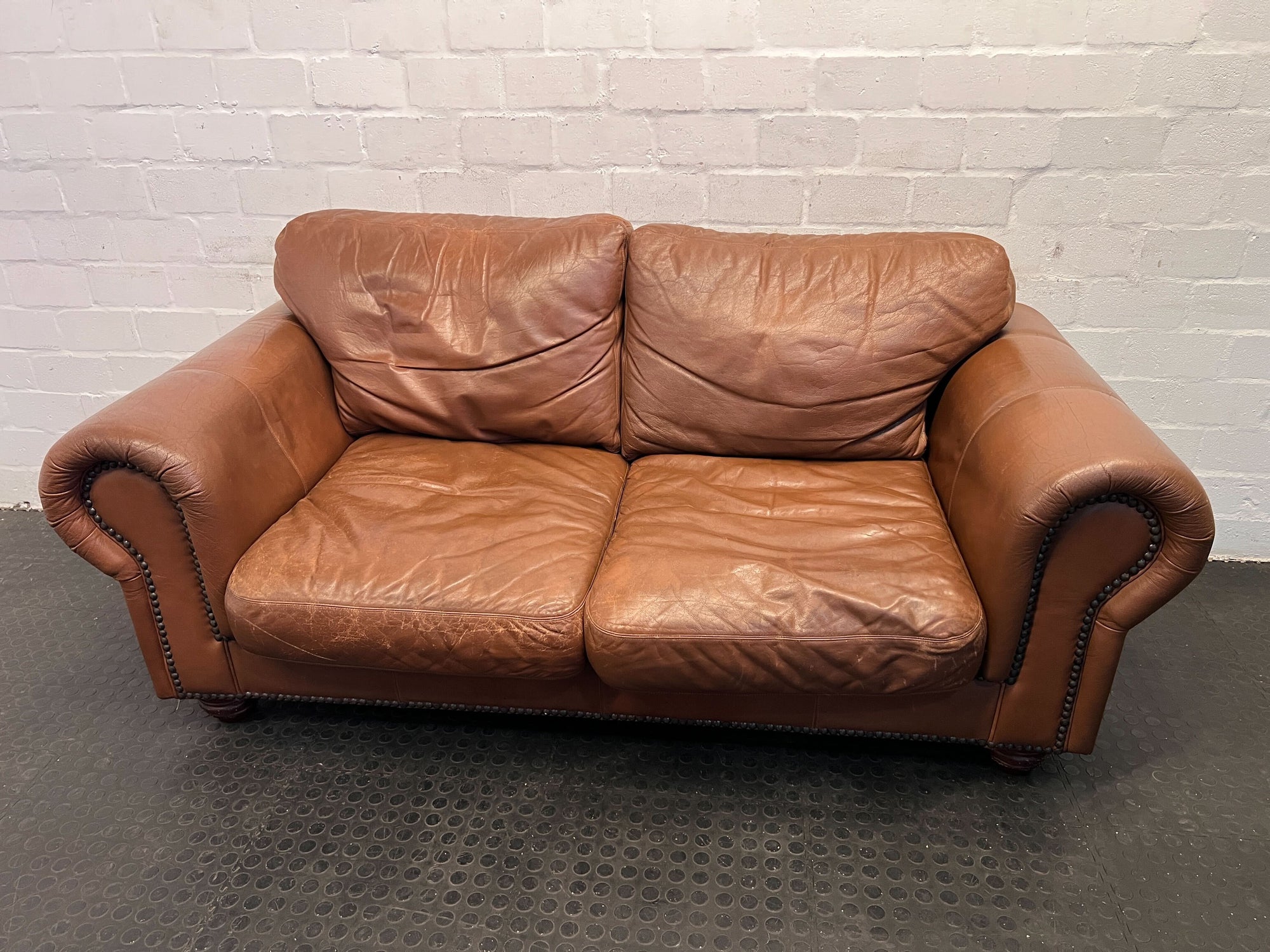 Brown Leather Two-Seater Sofa with Decorative Nails