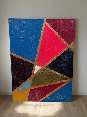 Abstract geometric painting with colorful triangles on a plain wall.