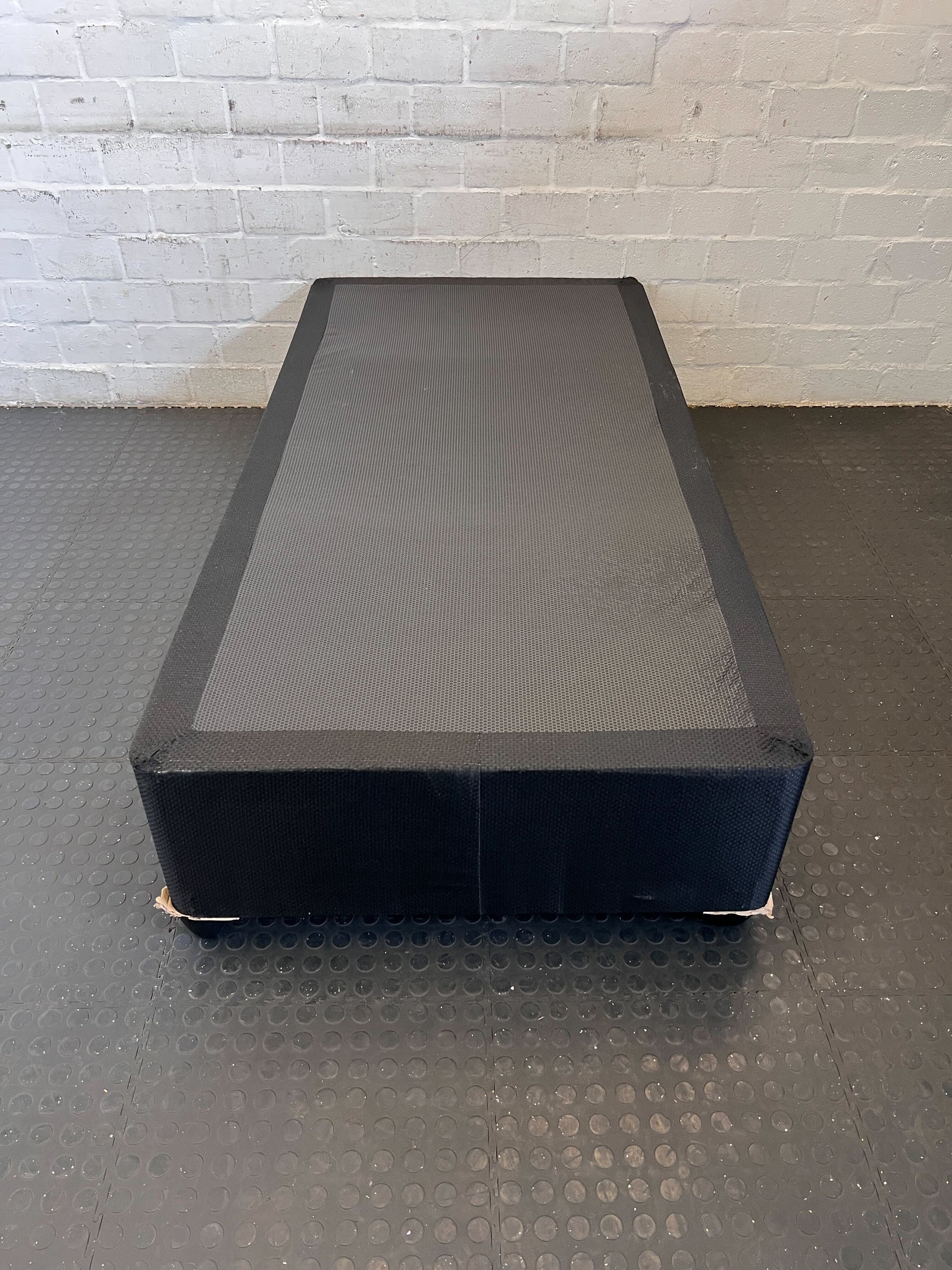 Comfortable Black Fabric Mattress with Minor Wear – Perfect for Any Bedroom