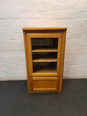 Oak-Toned Glass Door Display Cabinet with Drawer — Fair Condition with Visible Wear
