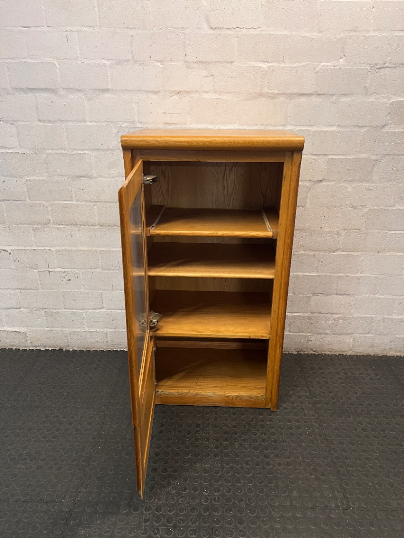 Oak-Toned Glass Door Display Cabinet with Drawer — Fair Condition with Visible Wear