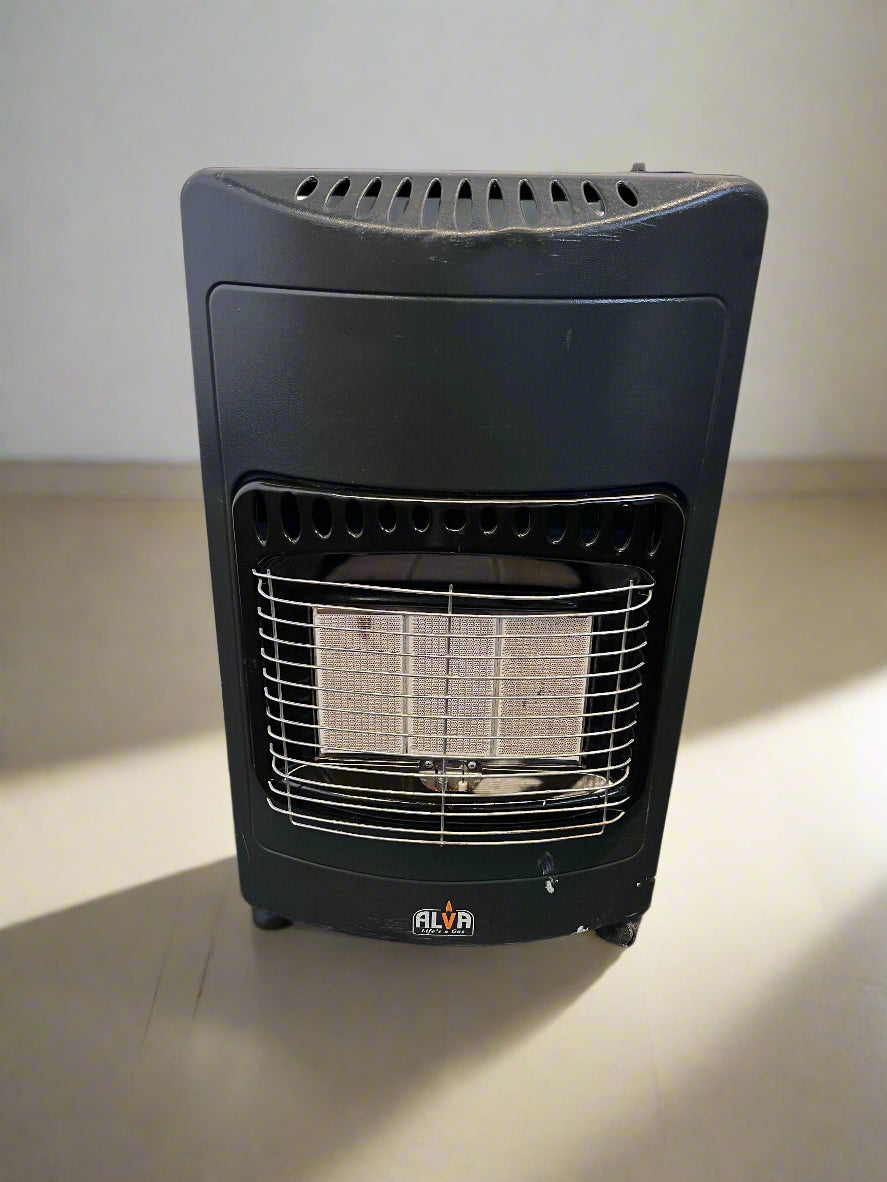 Black gas heater on a concrete floor with a brick wall background