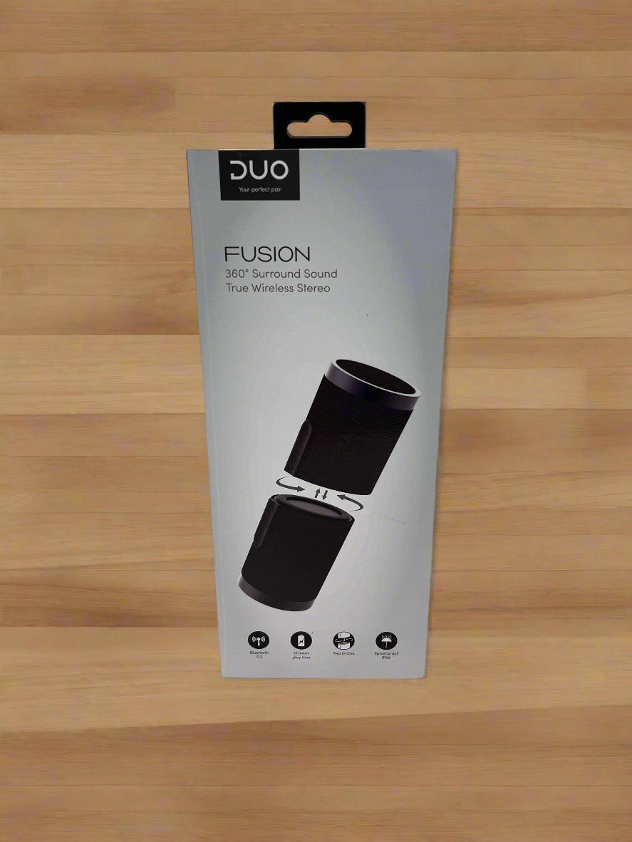 Packaging of DUO Fusion True Wireless Stereo speakers on a concrete surface