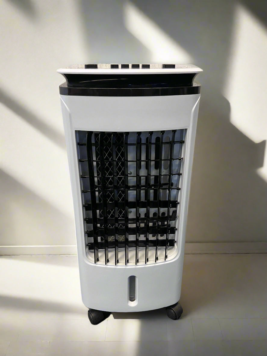 Portable air cooler on a black surface with a gray brick wall background
