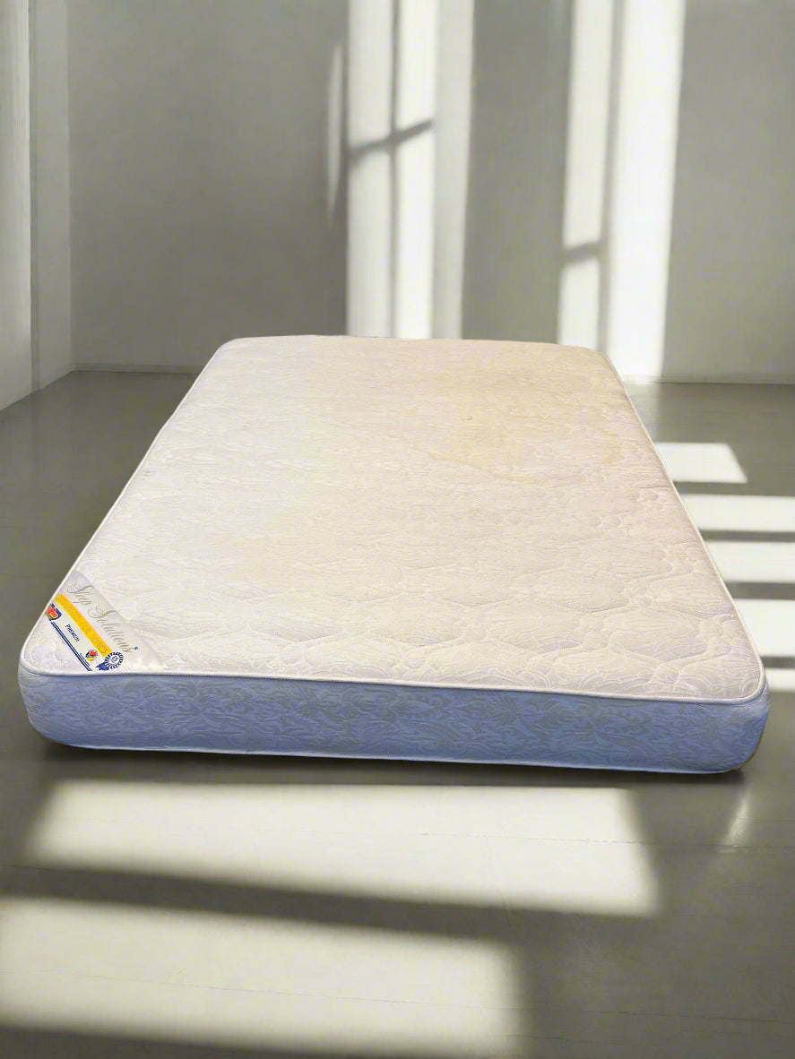 Mattress on a bed with a neutral background