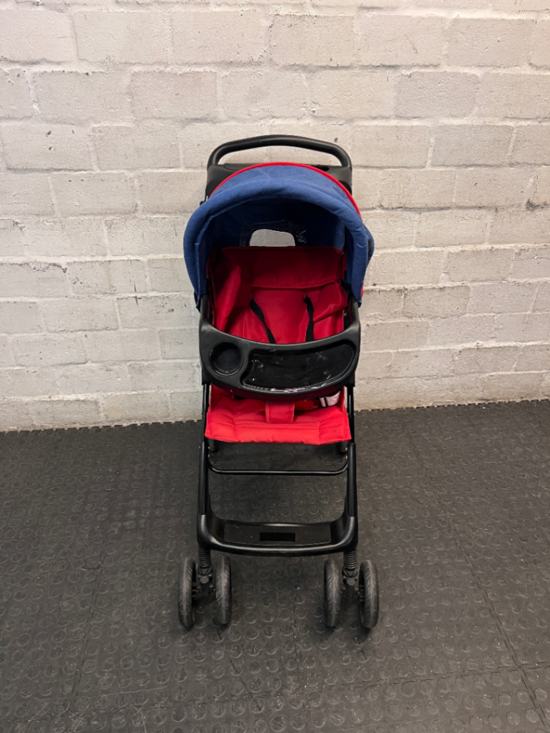 Red and Navy Four-Wheel Stroller with Snack Tray — Fair Condition with Signs of Use