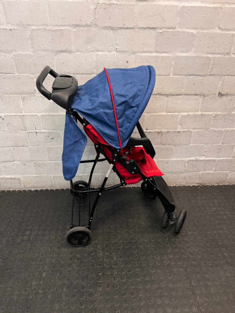 Red and Navy Four-Wheel Stroller with Snack Tray — Fair Condition with Signs of Use