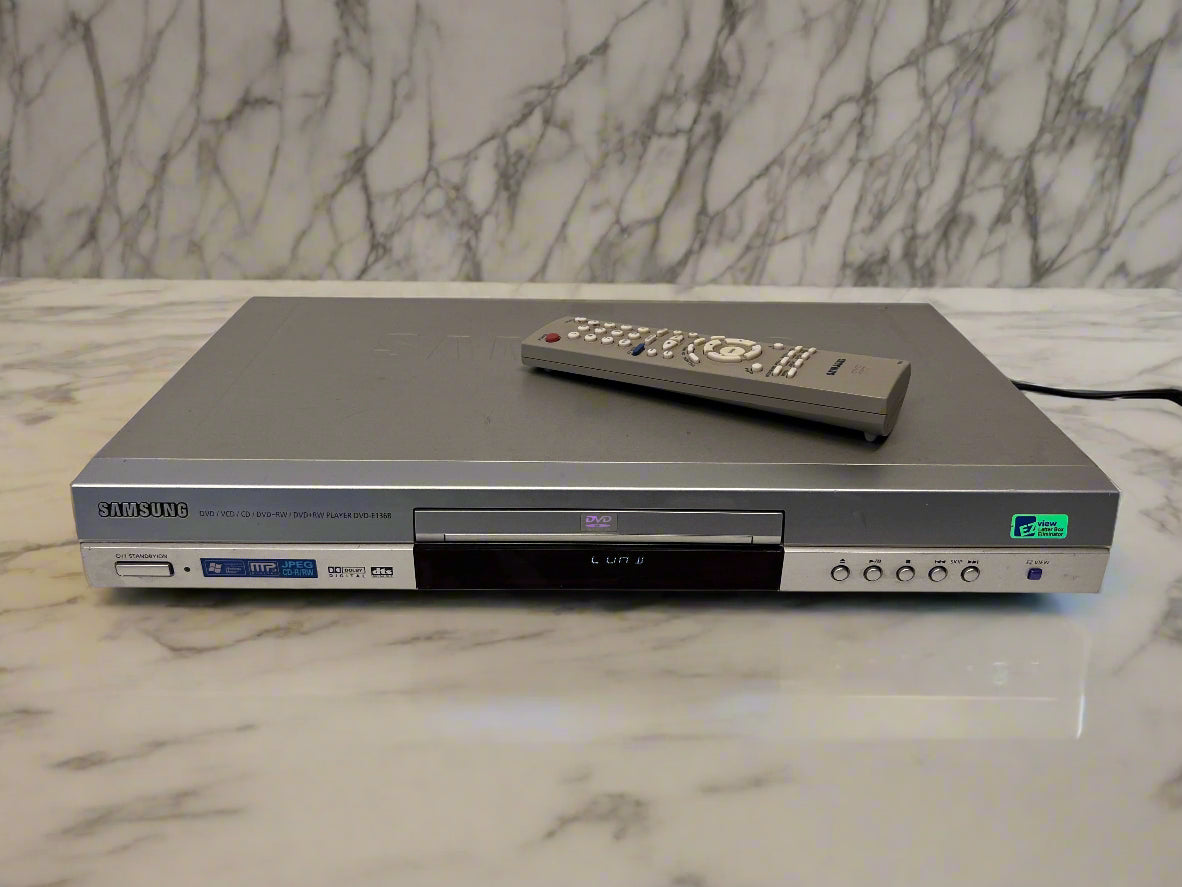 DVD player with remote control on a marble surface