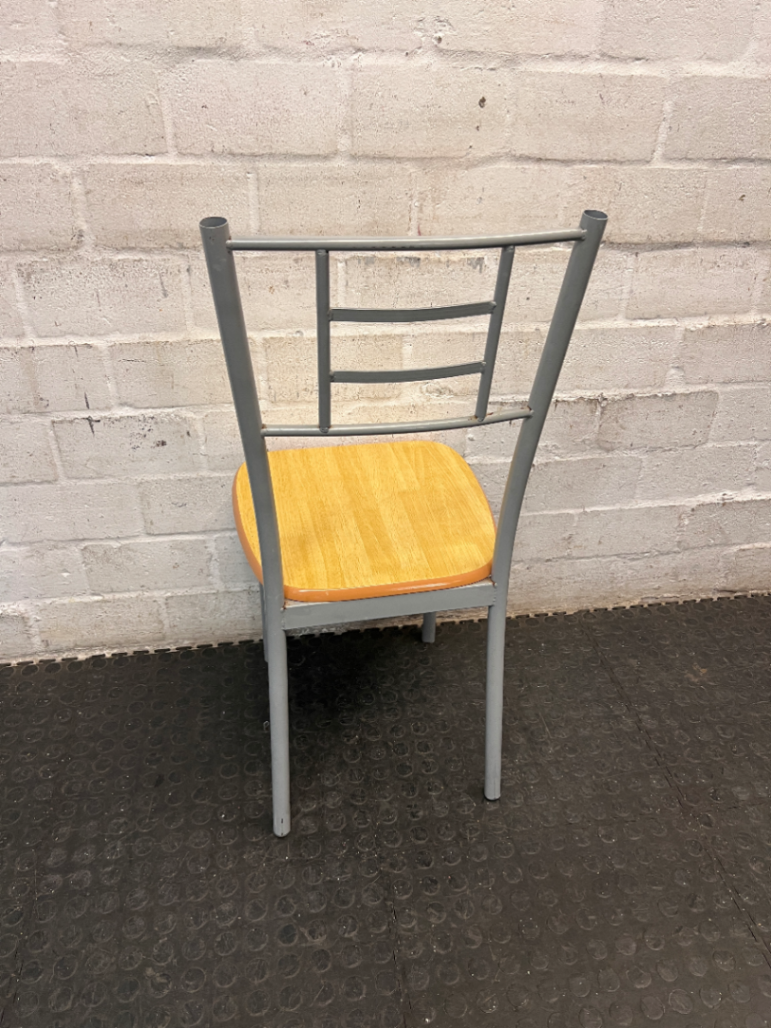 Silver Metal Dining Chair with Wood-Effect Seat — Visible Surface Wear and Scuffing