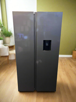 Side-by-side refrigerator with water and ice dispenser in a room with green walls and wooden floor.