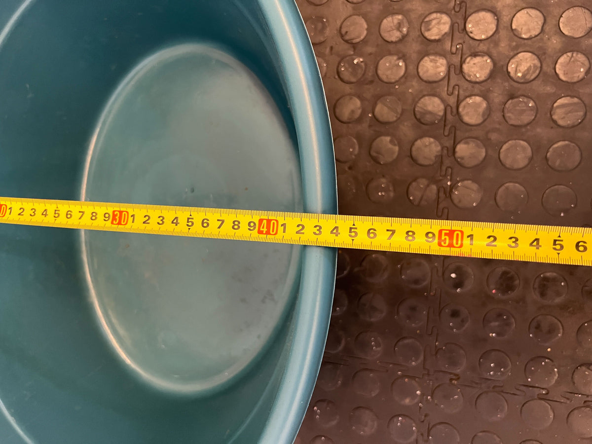 Spacious Turquoise Plastic Utility Tub with Minor Scratches
