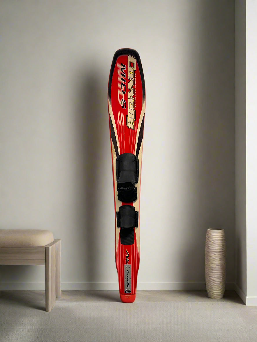 Red and black sports equipment against a white brick wall