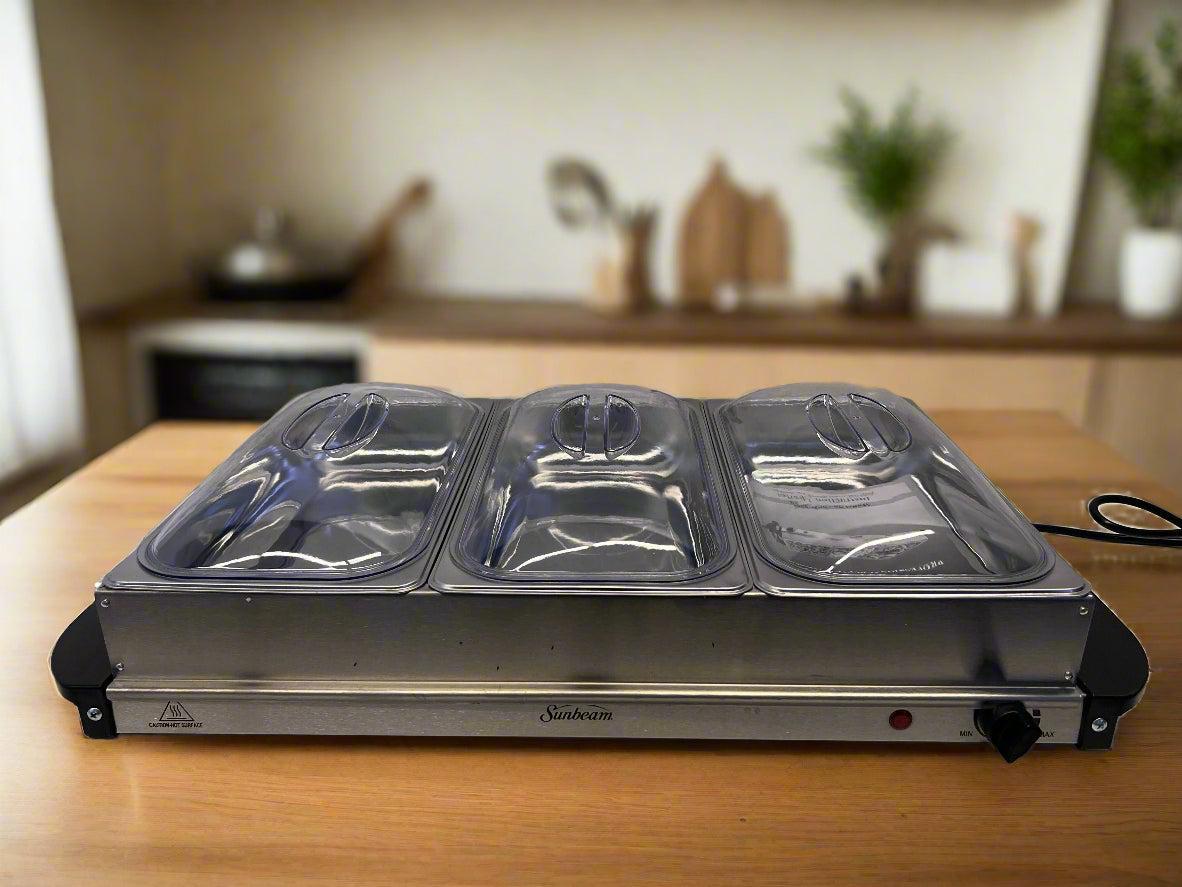 Hot plate with three compartments on a wooden surface in a kitchen setting