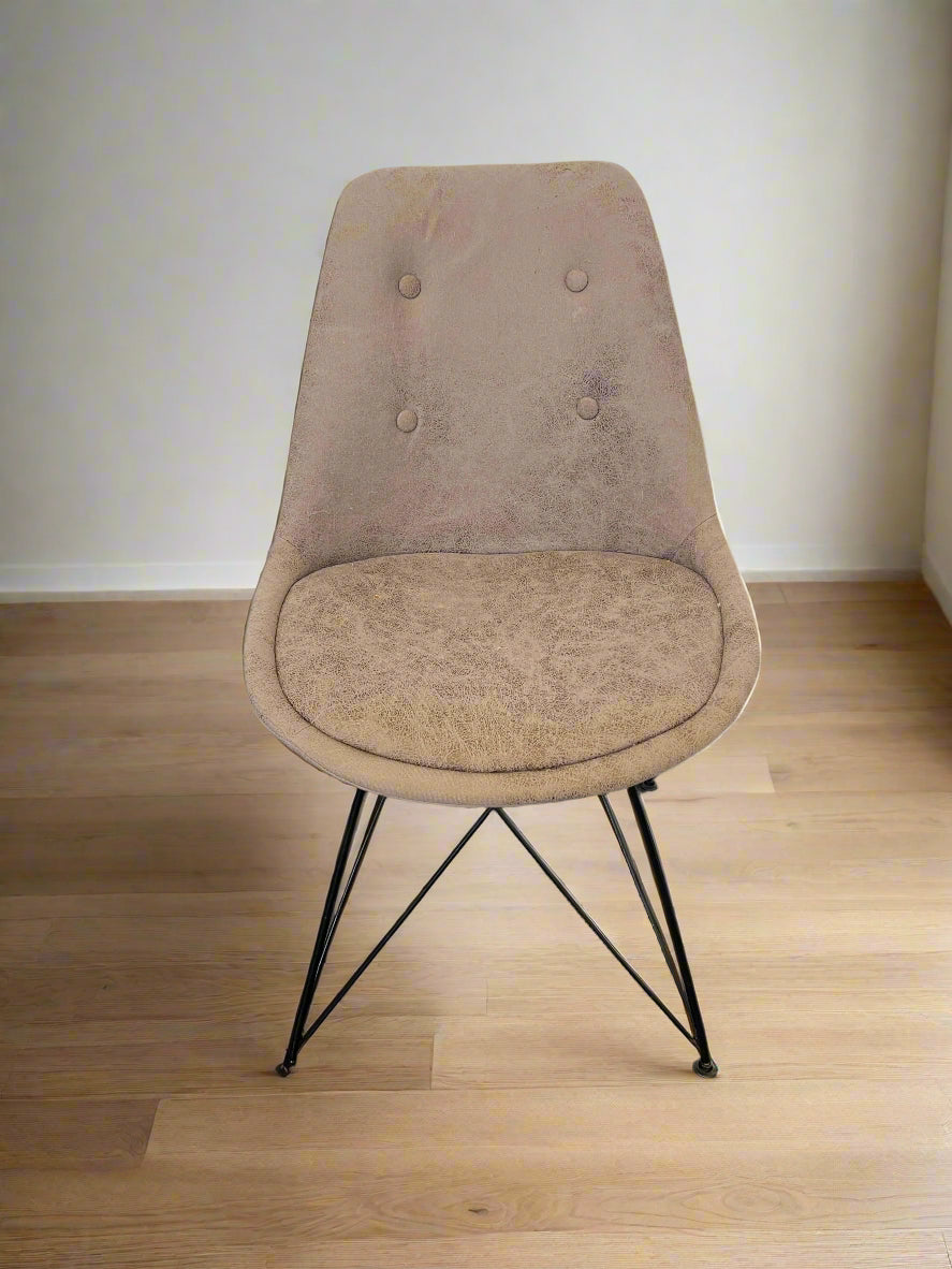 Beige chair with black metal legs on a dark floor and light gray wall background