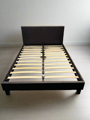 Wooden bed frame with slats on a plain background
