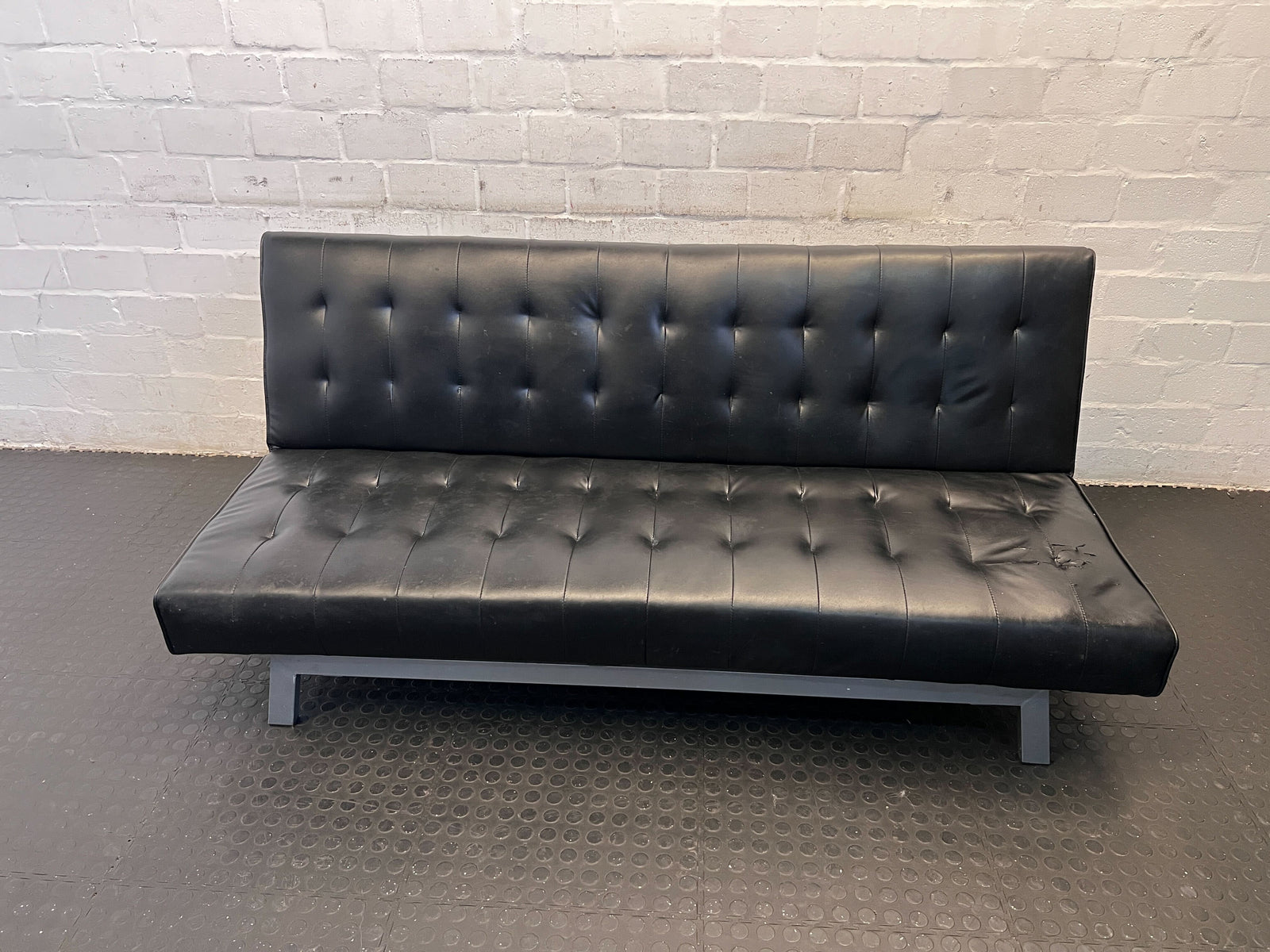 Stylish Black Faux Leather Sofa Bed with Fabric Tear