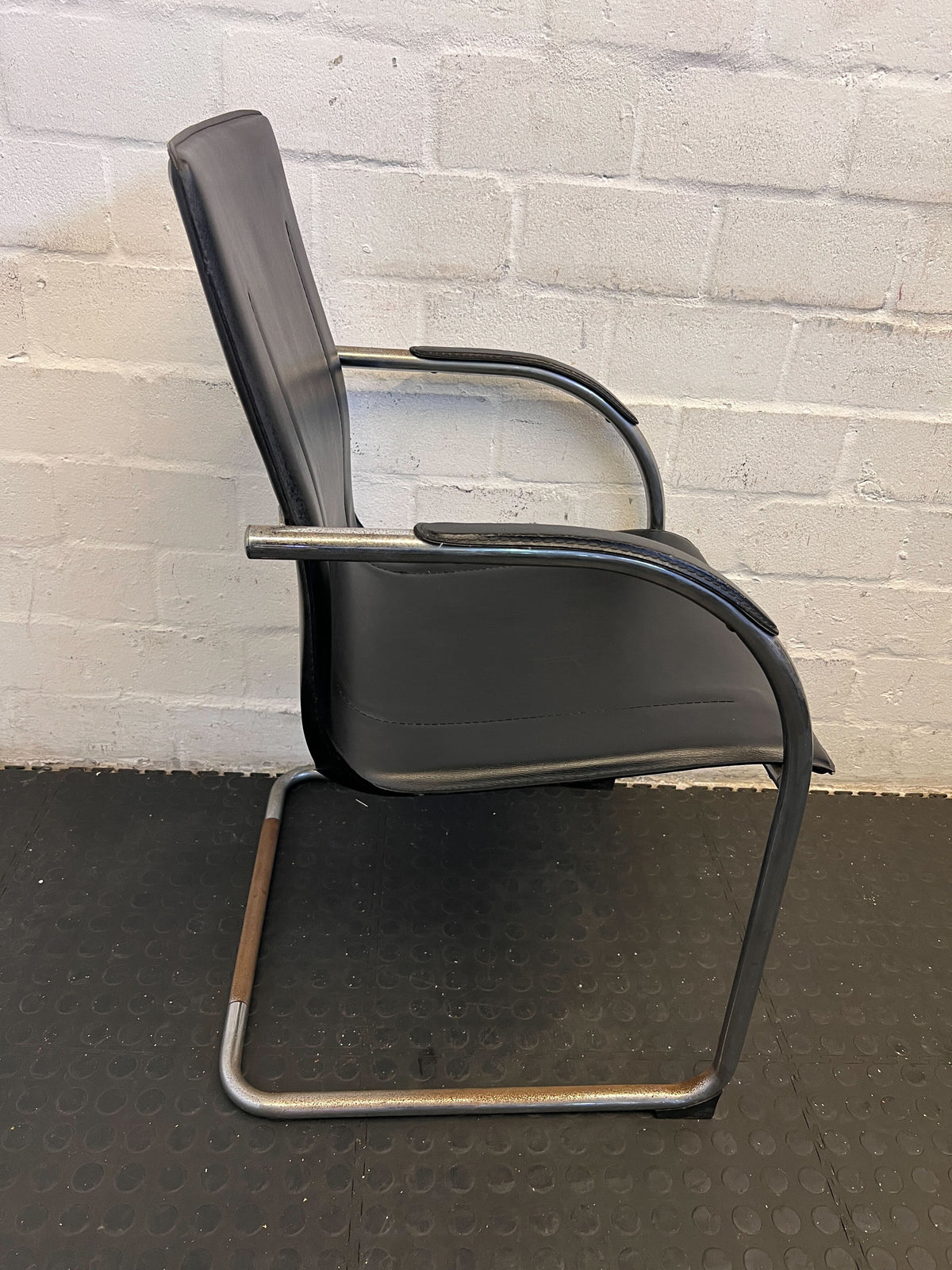 Stylish Black Leather Chair with Chrome Frame – Vintage Appeal Some Rust