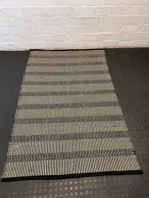 Stylish Black and White Woven Area Rug - Minimalist Design, Slight Wear