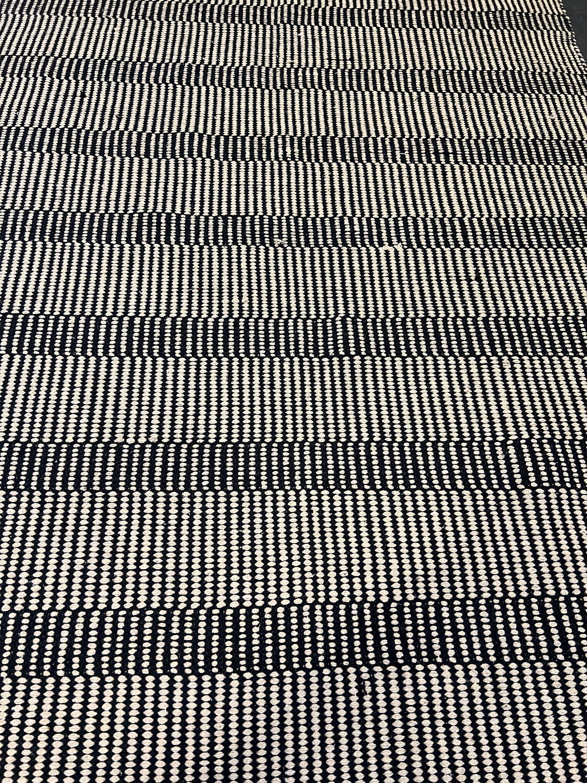 Stylish Black and White Woven Area Rug - Minimalist Design, Slight Wear