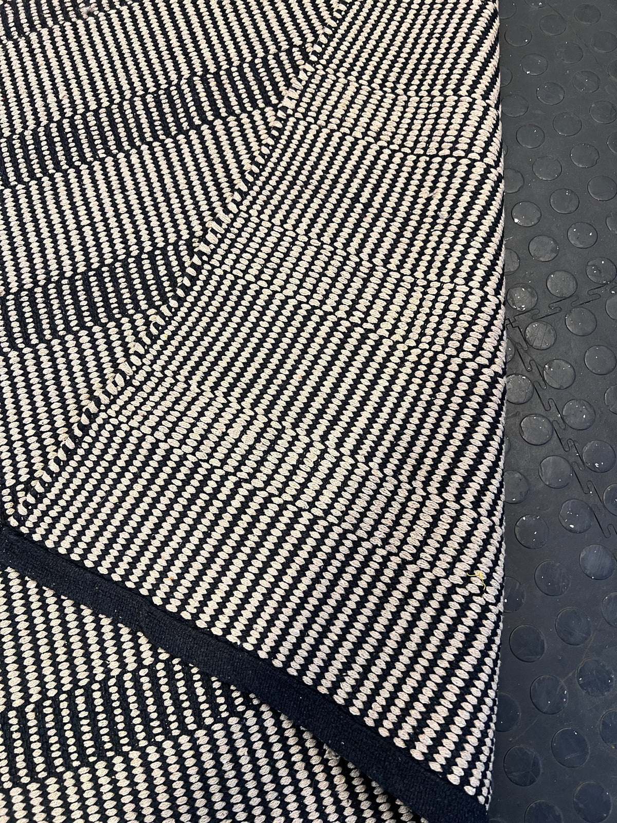 Stylish Black and White Woven Area Rug - Minimalist Design, Slight Wear