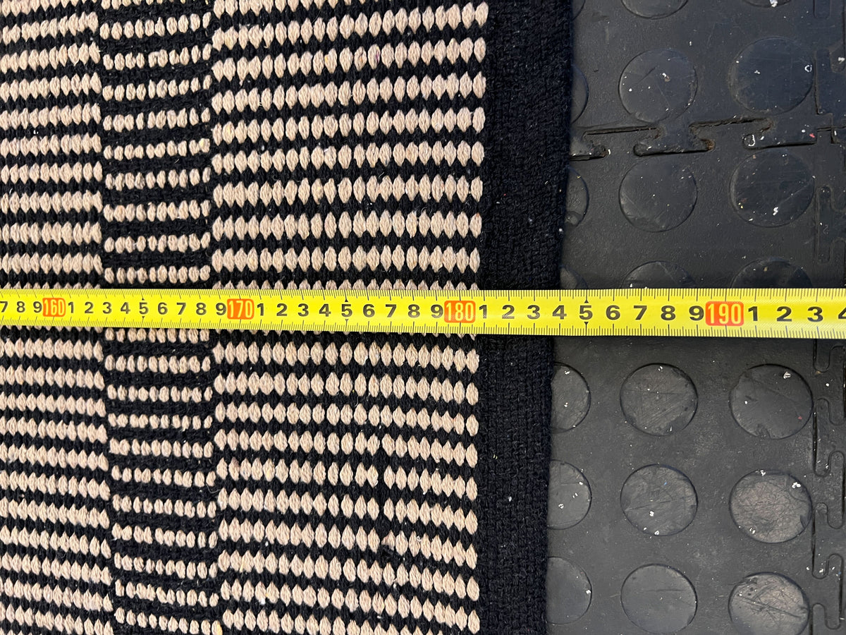 Stylish Black and White Woven Area Rug - Minimalist Design, Slight Wear