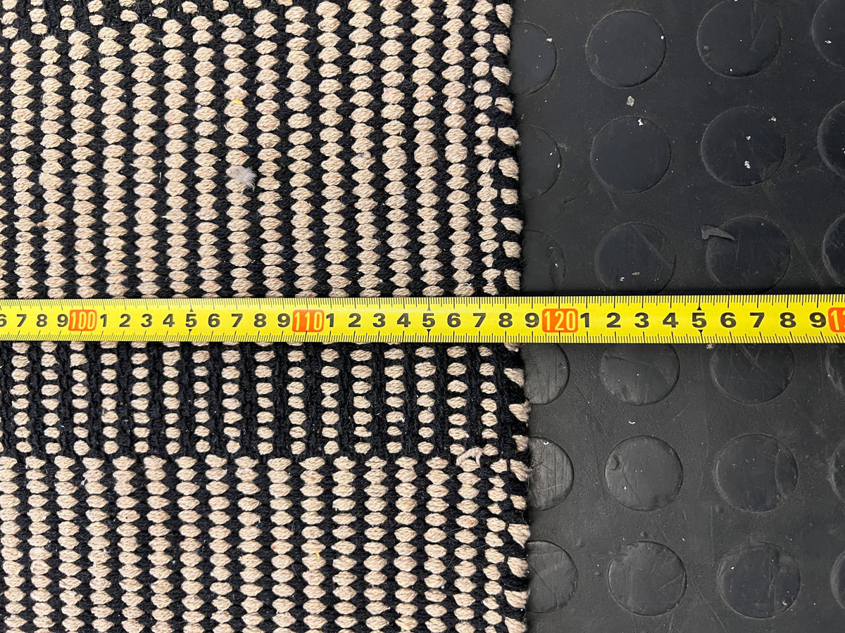 Stylish Black and White Woven Area Rug - Minimalist Design, Slight Wear