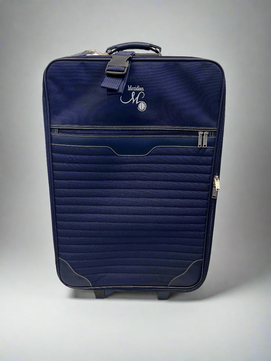Navy blue suitcase with a brand logo on a white surface and light gray background
