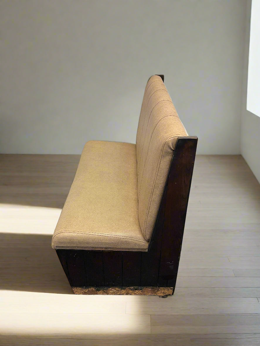 Beige bench against a white brick wall