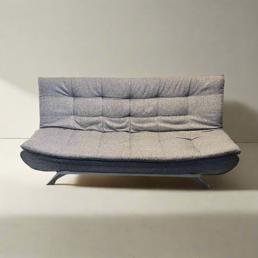 Gray upholstered sofa bed against a plain wall.